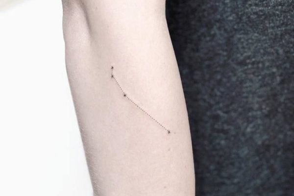 Minimalist Aries constellation tattoo on the finger.