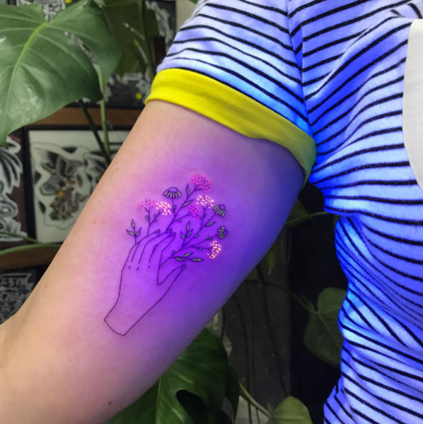 UV ink Totoro tattoo located on the shin.
