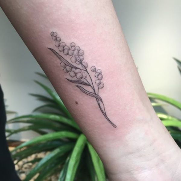 Micro-realistic calla lily tattoo on the inner forearm.